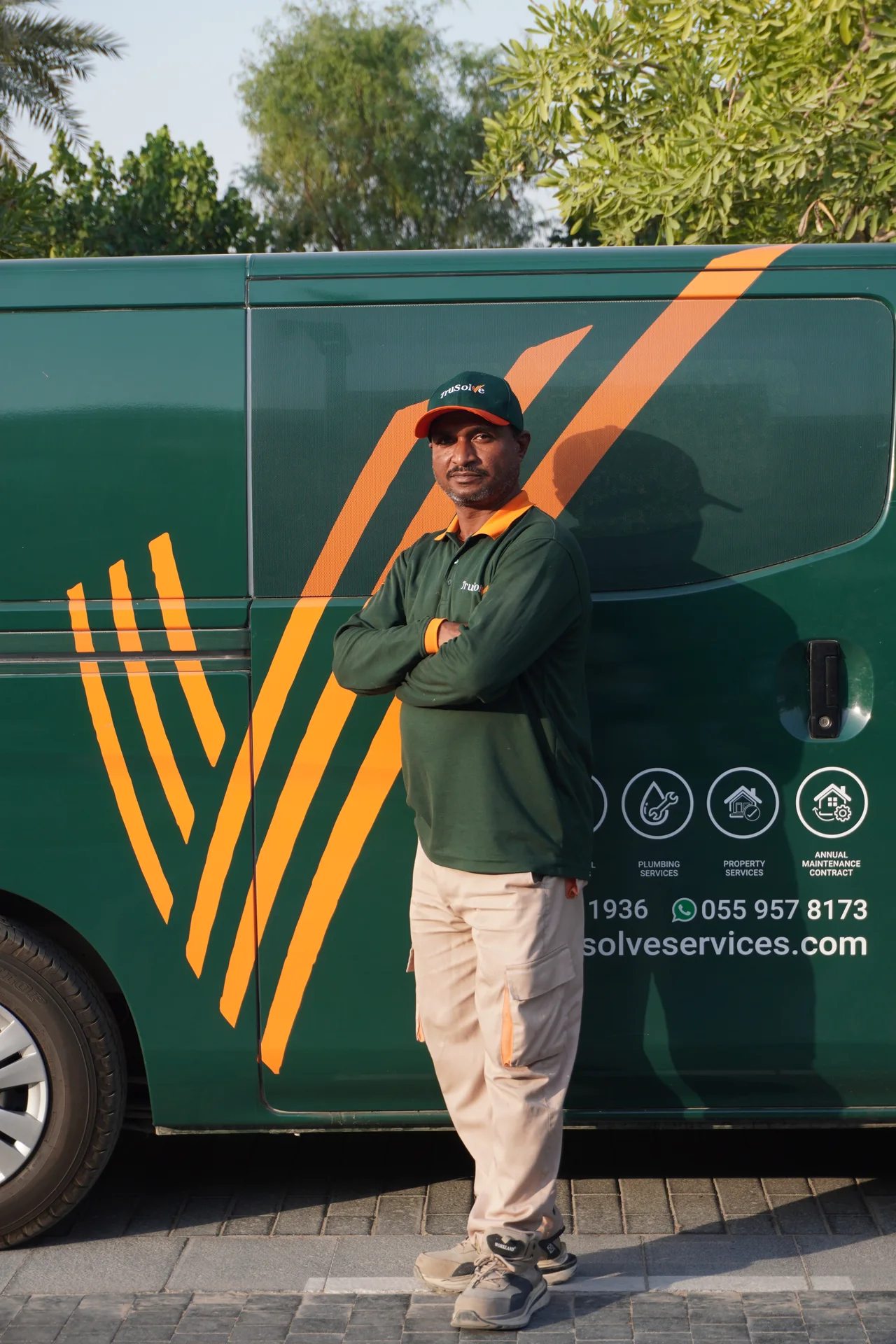 TruSolve technician standing beside the Tilal Al Ghaf service van